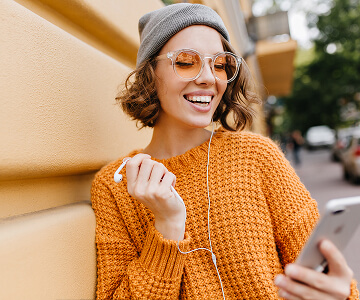 girl with headphones laughing
